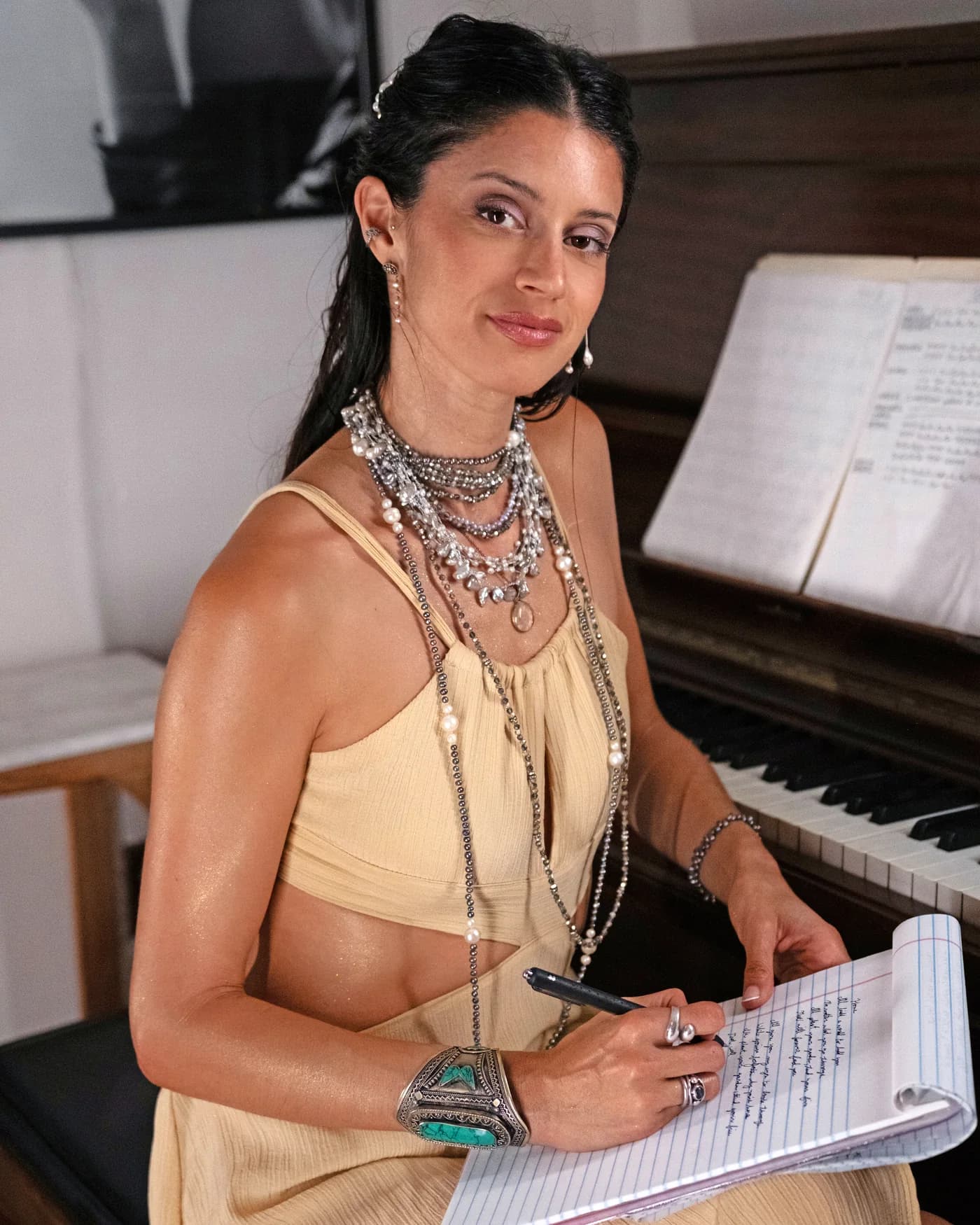 Julia, founder of Voice Alchemy Academy, writing at the piano